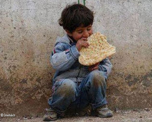 Un petit garçon libanais pauvre, mange du pain qu'on lui a donné!
